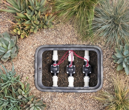 Close-up of an installed irrigation controller and system hardware